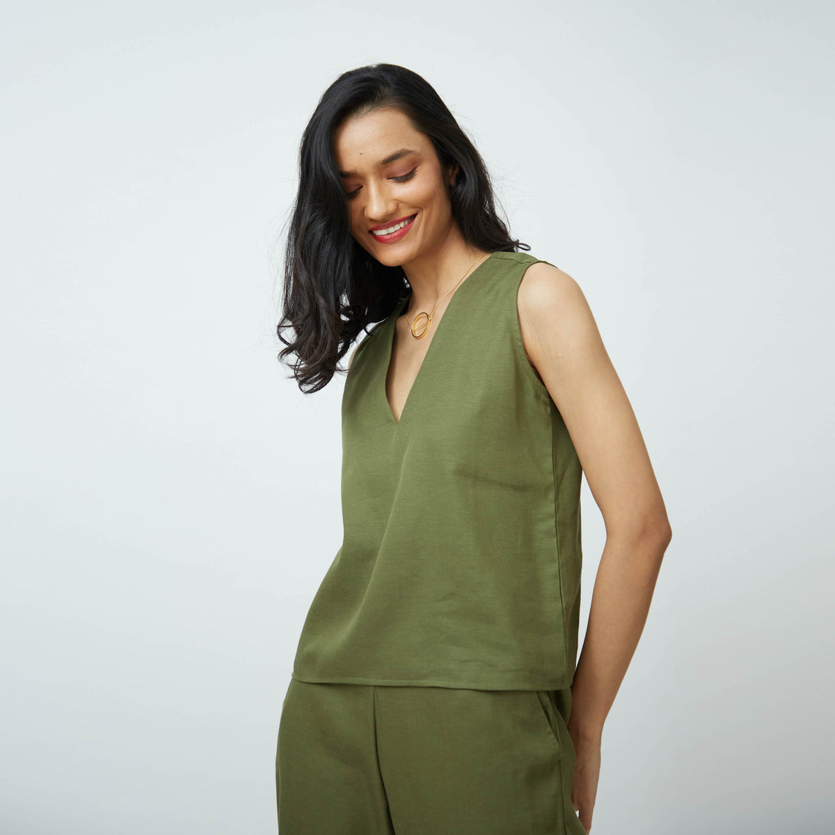 Saltpetre womens wear, indo-western shell top with v-shaped neck in olive green for semi formal, casual, occassional wear. Comfortably elegant woth delivate feminine straps.