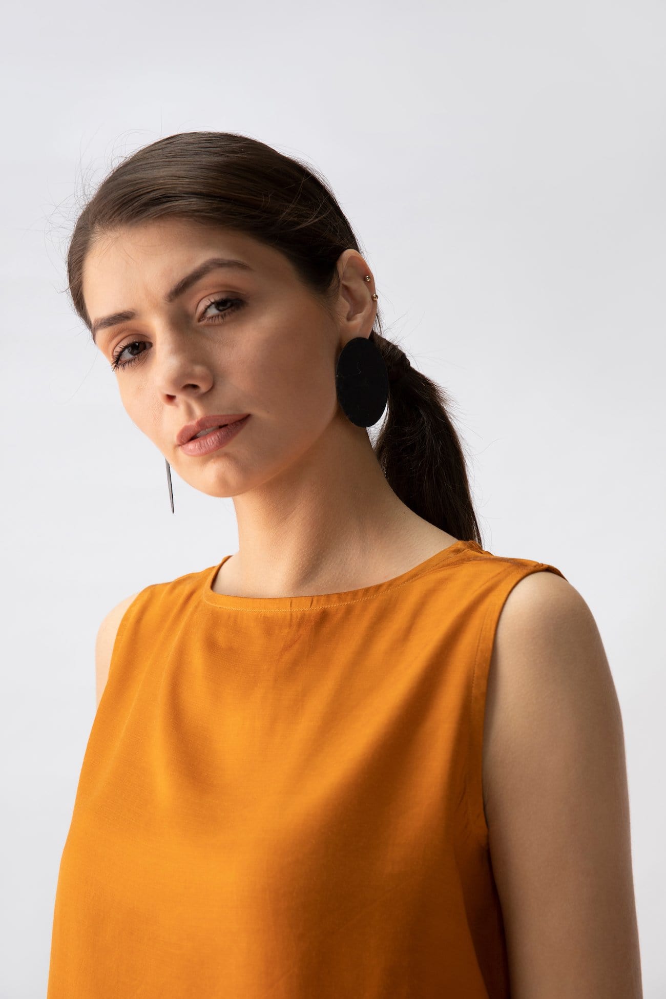 Saltpetre womens wear, indo-western shell top for semi formal, casual, occassional wear. Comfortably elegant woth delivate feminine straps in mustard yelow colour.